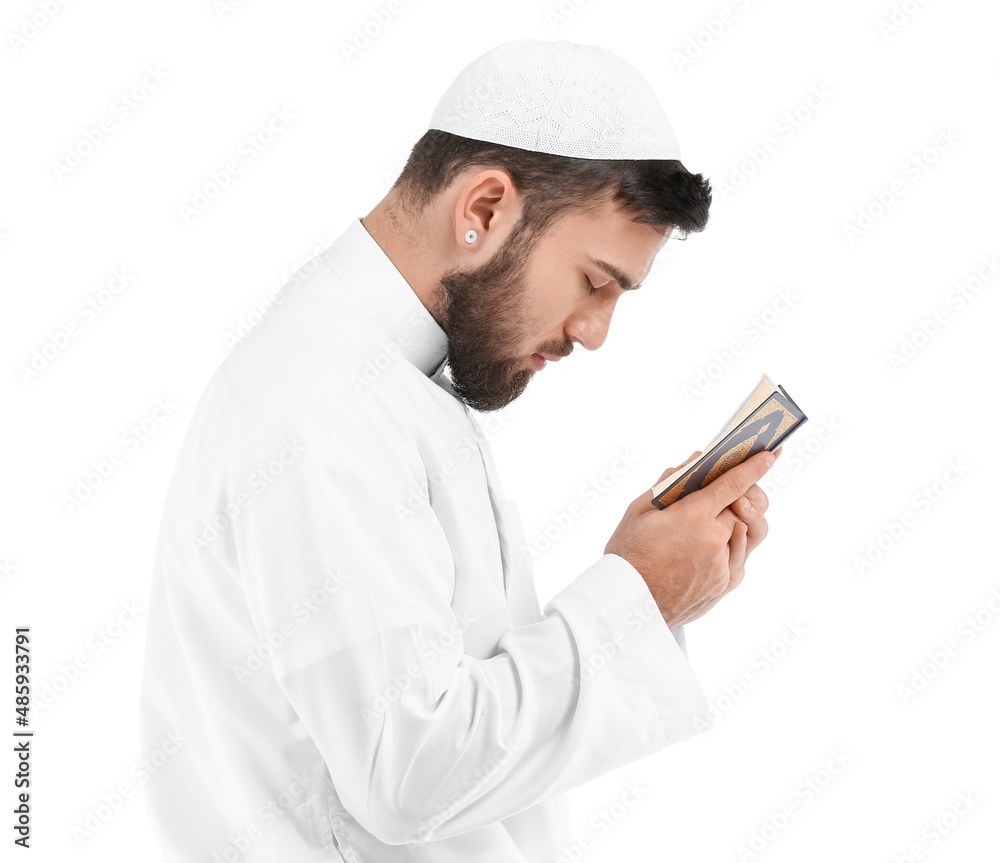 Wall mural Praying young Muslim man on white background