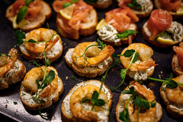 Selection of tasty bruschetta with salmon and shrimp.