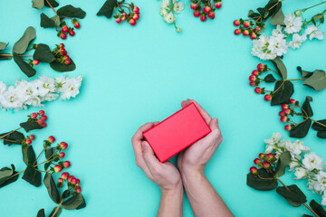 Flat lay of man hands holding gift wrapped and decorated. Man hand gift. Gift box. 