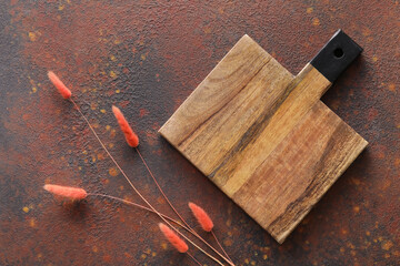 Wooden cutting board and spikelets on grunge background
