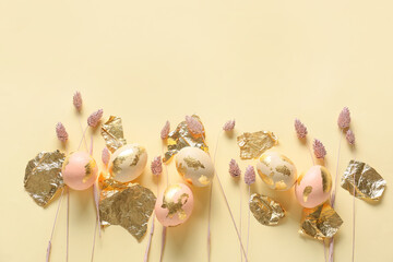 Composition with beautiful Easter eggs, foil and dried flowers on color background