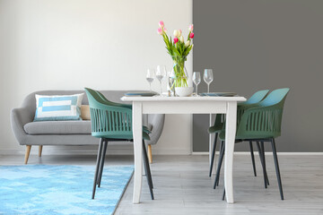 Interior of room with dining table served for International Women's Day celebration
