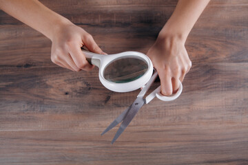 girl holding a scissor and magnifying glass
