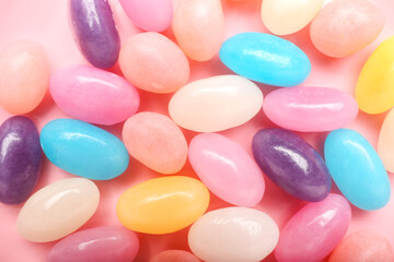 Multicolored jelly beans on color background