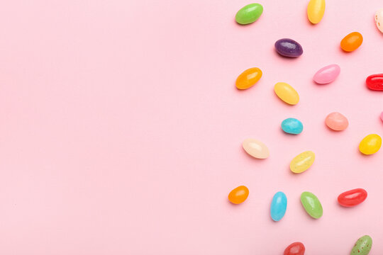 Multicolored jelly beans on color background