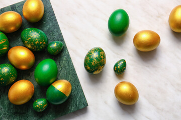 Board with stylish Easter eggs on light background