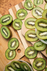 Fresh green kiwi cut into rings on a wooden background close-up.