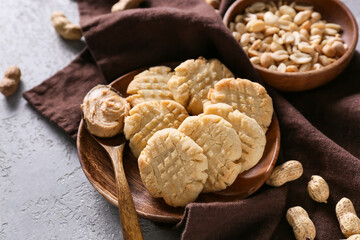 Plate with tasty peanut cookies on grey background