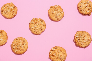 Tasty peanut cookies on pink background
