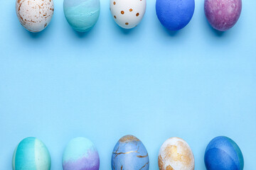 Composition with beautiful Easter eggs on blue background