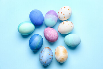 Many beautiful Easter eggs on blue background