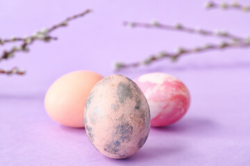 Beautiful Easter eggs on lilac background