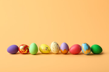 Fototapeta na wymiar Colorful Easter eggs on beige background