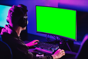 Rear view of professional gamer playing missions in game in gaming room. © Dusan Petkovic