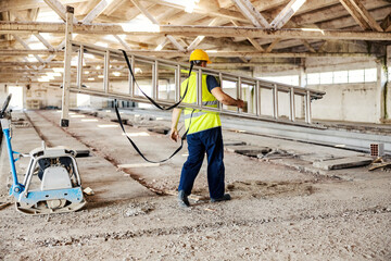 A worker carry ladders at construction site.