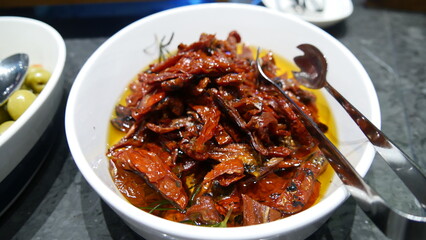 Appetizers of sun-dried tomatoes in a white bowl