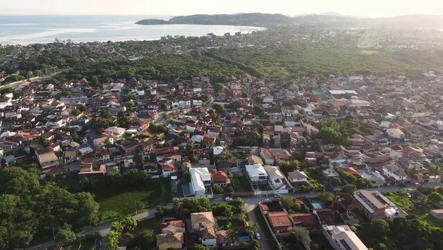 Beautiful seaside town with the sun rising - drone view - panorama - tropical beach - Arma&ccedil;&atilde;o de B&uacute;zios, Rio de Janeiro, Brazil