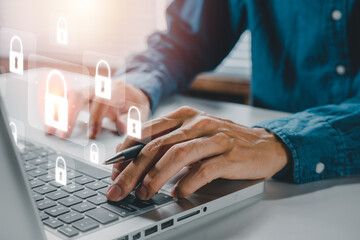 Cyber security concept, Businessman hand using computer with padlock security interface to protect data on desk, internet security.