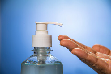 hand with cleansing gel bottle