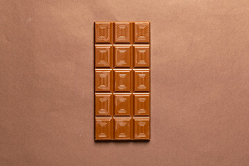 Bar chocolate on brown background
