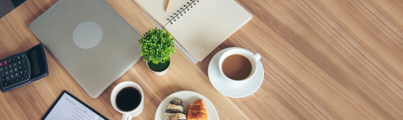 Meeting room Office laptop business financial document chart , graph on wooden table with coffee cup. Flat lay notebook computer laptop on office desk. No people business graph chart on meeting table