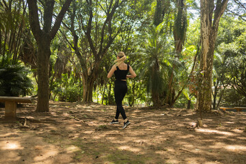 Young woman running and jogging at a park outdoors. Athlete female person during workout. High quality photo