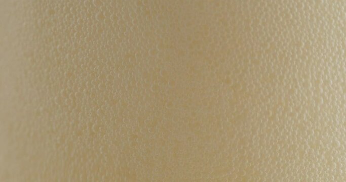 Many  beer foam on the surface of the drink. Soft white foam on the surface of the drink. Food concept.