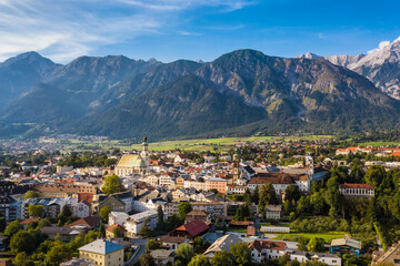 Fototapeta na wymiar Austria small town with spire church mountain backdrop