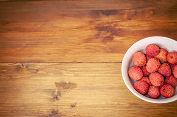 Fototapeta premium fresh organic lychee fruit and old wood background. Top view photo with copy space