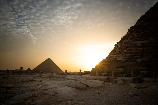 great pyramid of Mikerina and pyramid of cheops in Cairo, Egypt. Pyramids of Menkaura against blue cloudy sky in the evening at a beautiful sunset