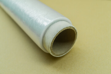 Roll of food stretch film for food packaging. Packaging film in a roll on a cardboard spool. Selective focus