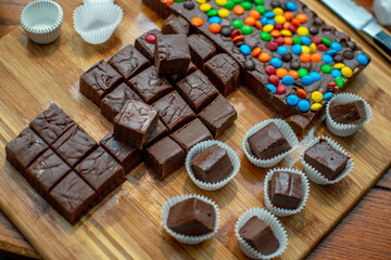 Chocolate fudge and fudge with candy dots are being made at home for sweet trays during the holidays