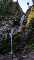 a two-stage waterfall in a mountain gorge. a beautiful tourist place