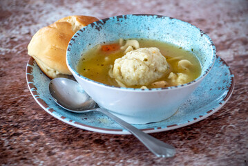 comforting bowl of chicken soup and a matzo ball