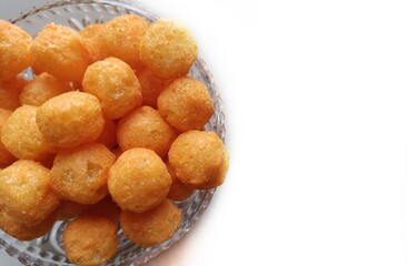 Cheese puffs balls, cheese curls, cheese ball puffs, cheesy puffs, or corn curls are a puffed corn snack, coated with a mixture of cheese or cheese-flavored powders.