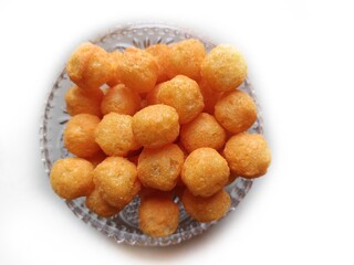 Cheese puffs balls, cheese curls, cheese ball puffs, cheesy puffs, or corn curls are a puffed corn snack, coated with a mixture of cheese or cheese-flavored powders.