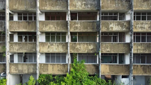 Abandoned deserted apartment or office building. Pan from bottom to top, several storey or levels high.