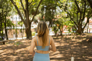 Naklejka premium Young woman running and jogging at a park outdoors. Athlete female person during workout. High quality photo