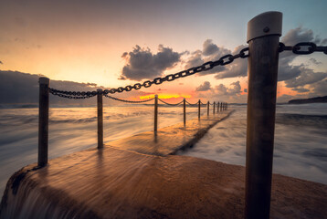Obraz premium sun set over the rock pool in sea