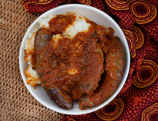 Traditional south African pap and Wors, maize meal with sausage and chakalaka sauce. flat lay on...