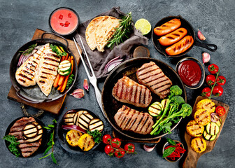 Grilled barbecue meat assortment on dark background.