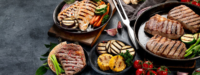 Grilled barbecue meat assortment on dark background.