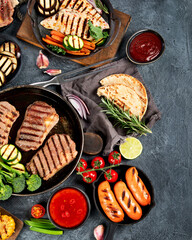 Grilled barbecue meat assortment on dark background.