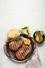 Grilled steak on light background. Homemade food concept.