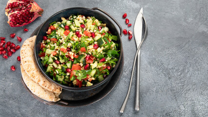 Fresh Tabbouleh salad on dark background.