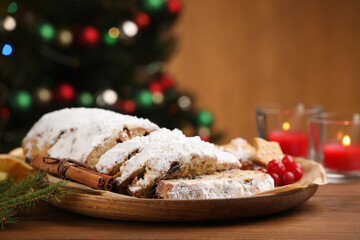 Fototapeta na wymiar Traditional Christmas Stollen with icing sugar on wooden table