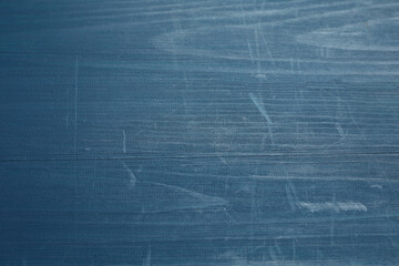 Old blue wooden surface with scratches as background, closeup