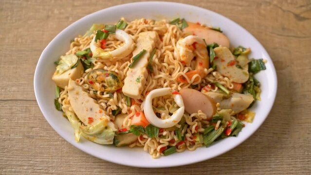 Instant noodle spicy salad with mixed meats - Asian food style