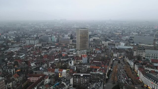 Aerial view of beautiful historic city of Sofia with skyscraper tower and driving cars on road during foggy day in Bulgaria