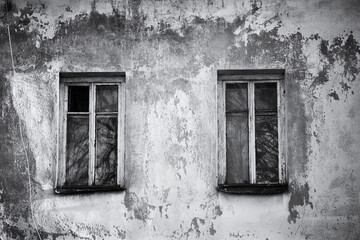 Wall with windows of an old abandoned house. Abstract NOIR background, black and white image.